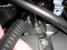 Loosening valve cover bolt - click for larger image