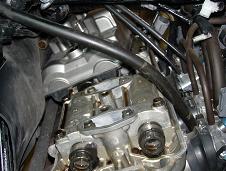 Loosening valve cover bolt - click for larger image